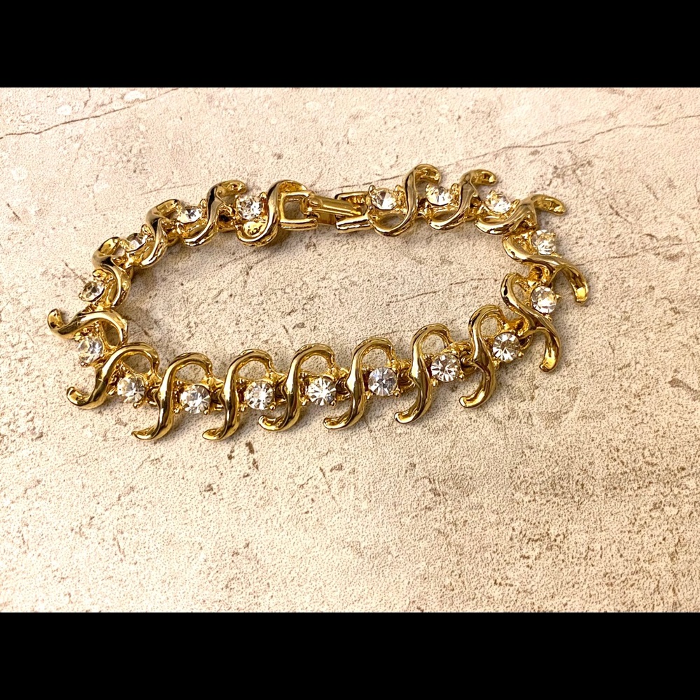Gold colored bracelet with clear stones